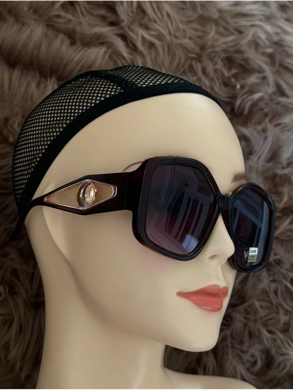 Futuristic sunglasses with large button detail on the sides